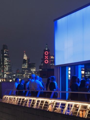 The Buffini Chao Deck event hire space - terrace exterior at night, looking east to the City