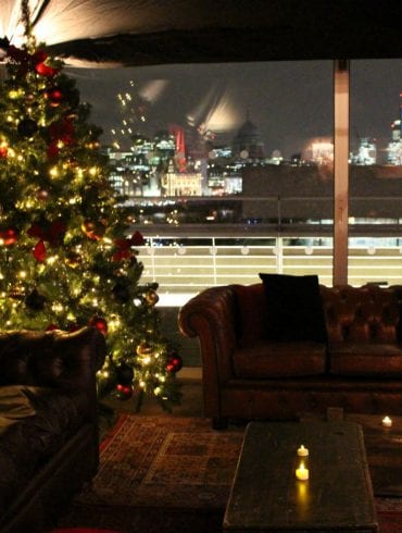 A Christmas theme, with decorated tree, leather sofas and a view towards St Paul's
