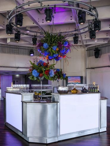 The Buffini Chao Deck event hire space: with bar and floral arrangements