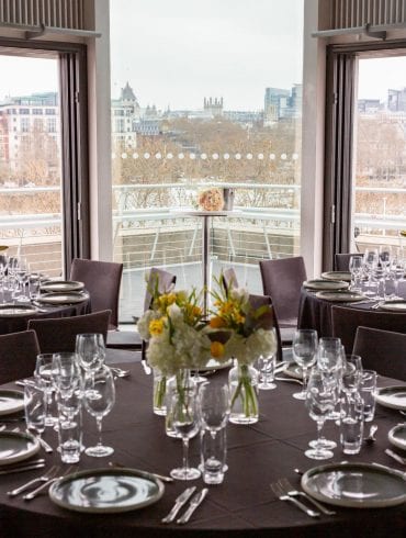 The Buffini Chao Deck event hire space: celebration setup with tables and flowers