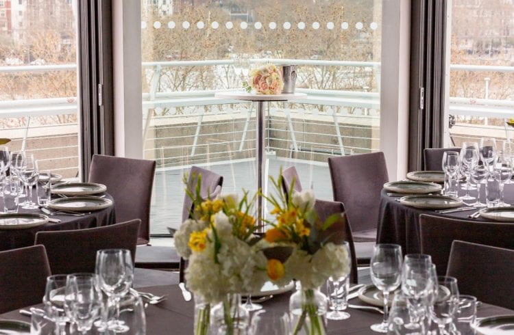 The Buffini Chao Deck event hire space: celebration setup with tables and flowers