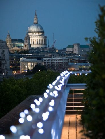 The Buffini Chao Deck event hire space: the terrace at night with fairy lights and views towards St Paul's