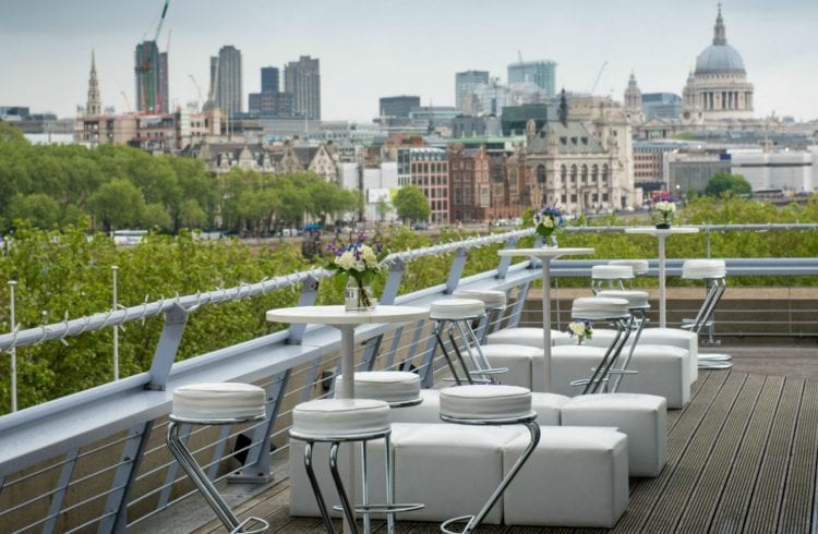 The Buffini Chao Deck event hire space: the terrace with white furniture and views towards the city