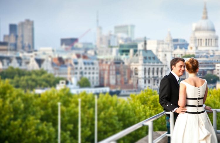 The Buffini Chao Deck event hire space - wedding couple on terrace, daytime, looking east