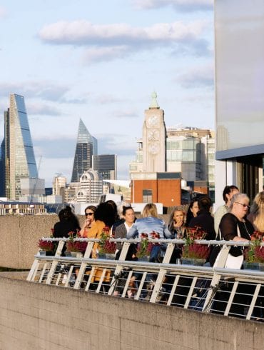 The Buffini Chao Deck event hire space: the terrace with people and views towards the city